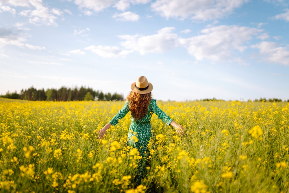 Happy,Woman,Walking,In,Flowering,Field.,Fashion,,Beauty,Concept.,Summer Ayurveda